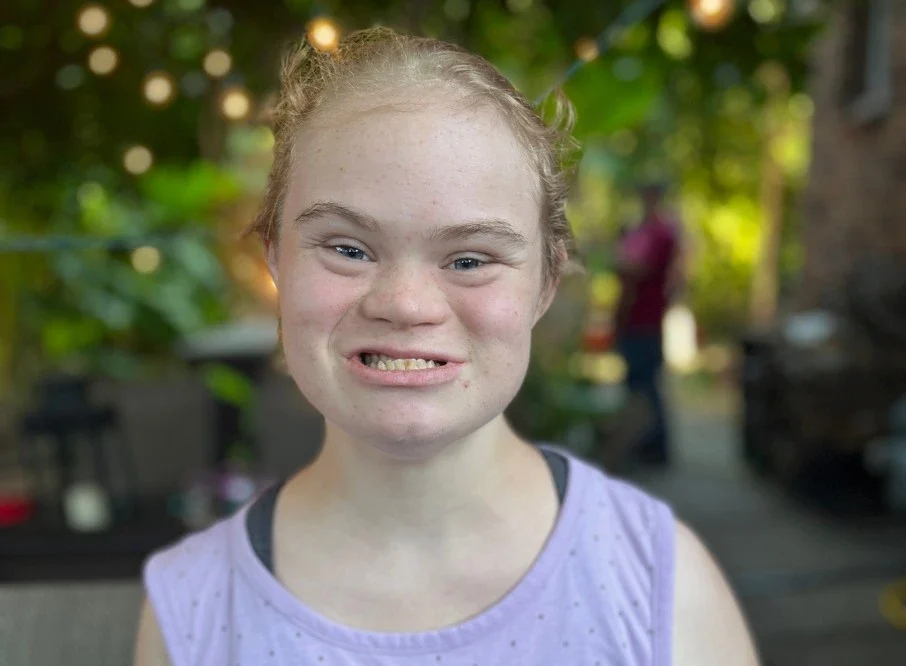 Happy disabled girl smiling at camera